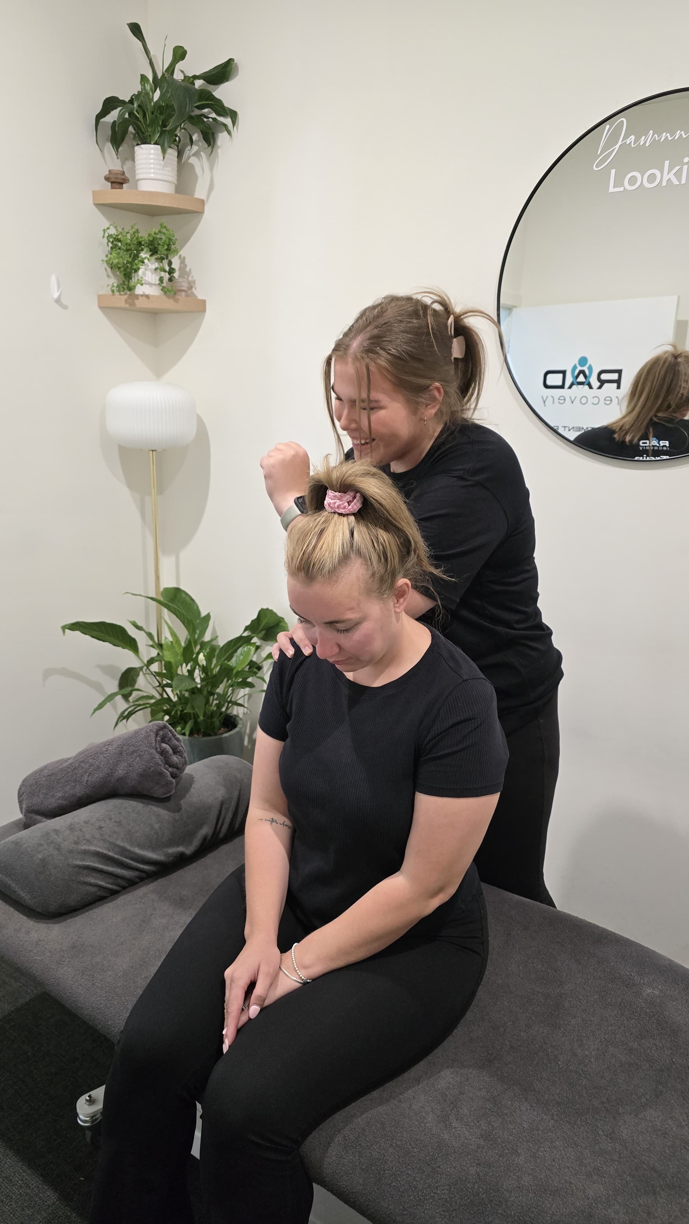 Hayley Pearce treating a seated client's neck and shoulders at RAD Recovery in Lilydale.